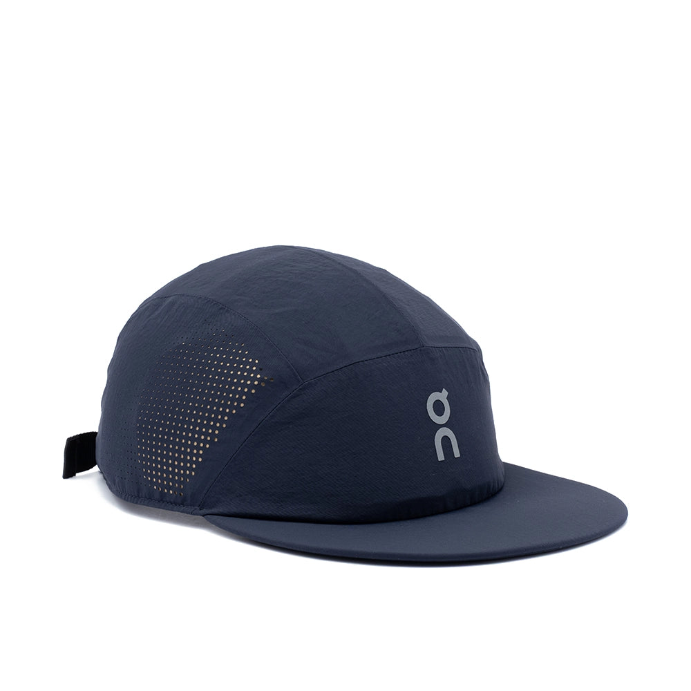 A dark navy blue 5-panel running cap with a flat brim, featuring a white 'on' logo on the front panel and a breathable perforated side panel, shown on a plain white background.