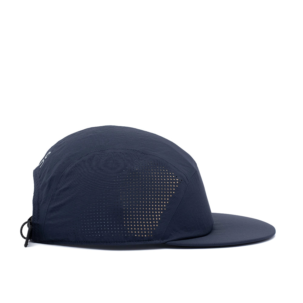 A dark navy blue 5-panel running cap with a flat brim and a subtle dotted pattern on the front panels, shown from a side profile on a white background.