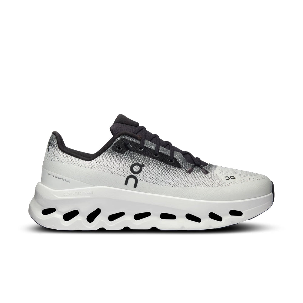 Side profile of the On Cloudtilt Black Ivory sneaker with a black On logo and cutout cushioning sole.