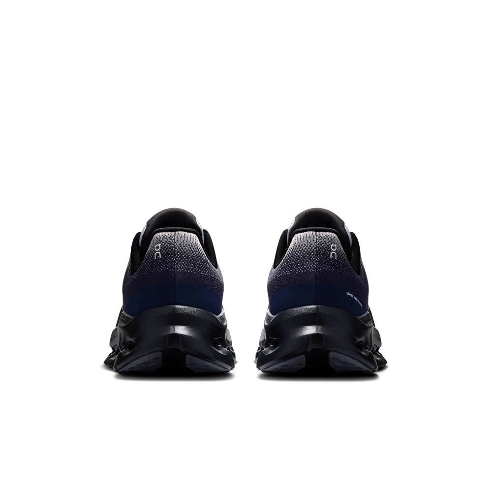 Rear view of On Cloudtilt Platinum Midnight sneakers with navy heels, gray knit collars, and black sculpted soles.
