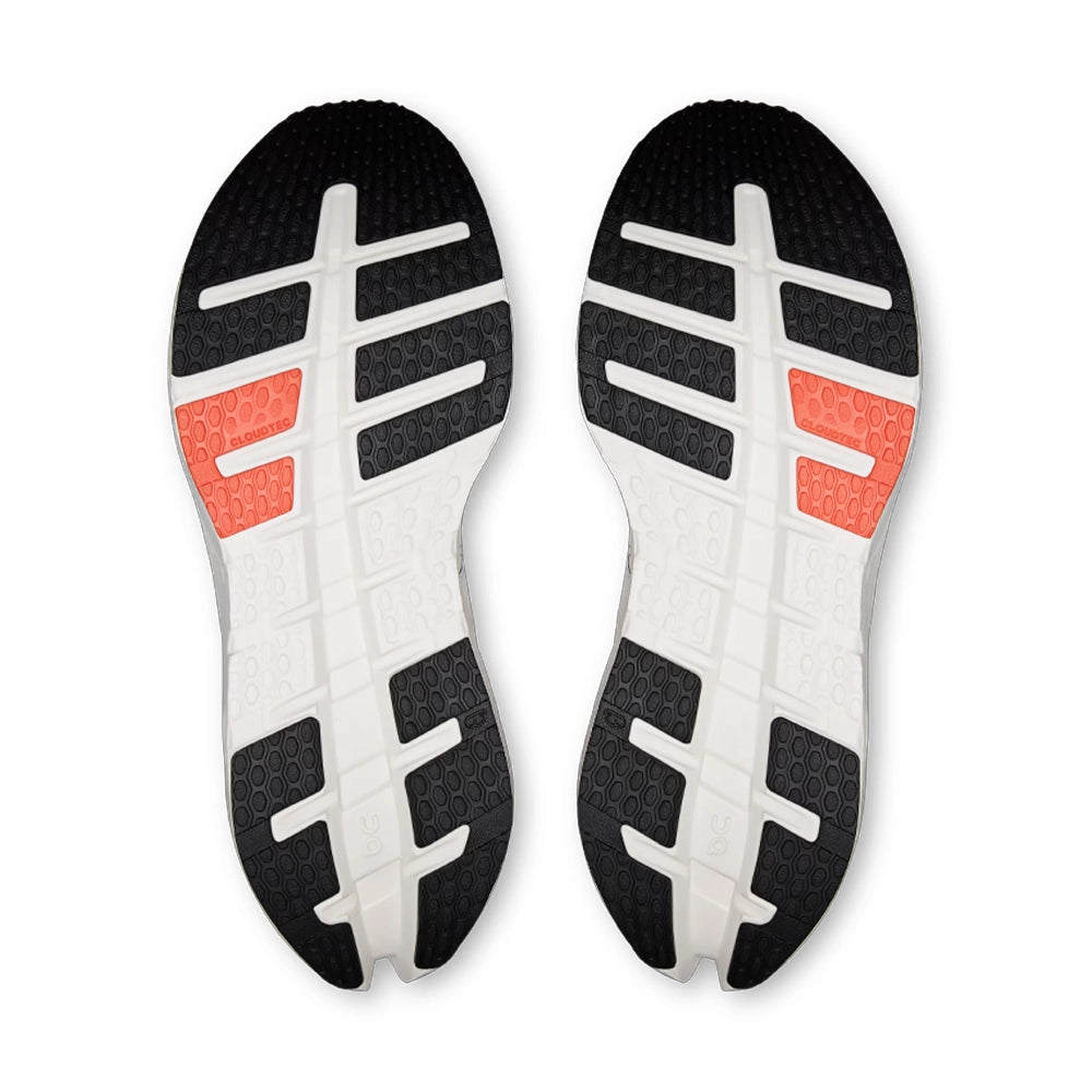 Outsoles of On Cloudrunner 3 Ivory Flame running shoes with black and orange rubber sections on a white base.