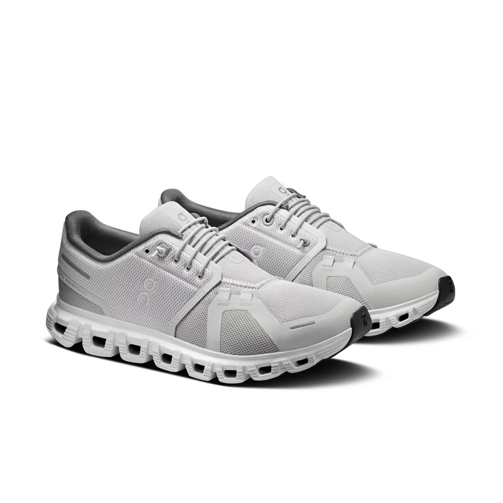 Pair of women's On Cloud 6 Glacier Eclipse sneakers, angled front view with light grey uppers and dark grey lining.