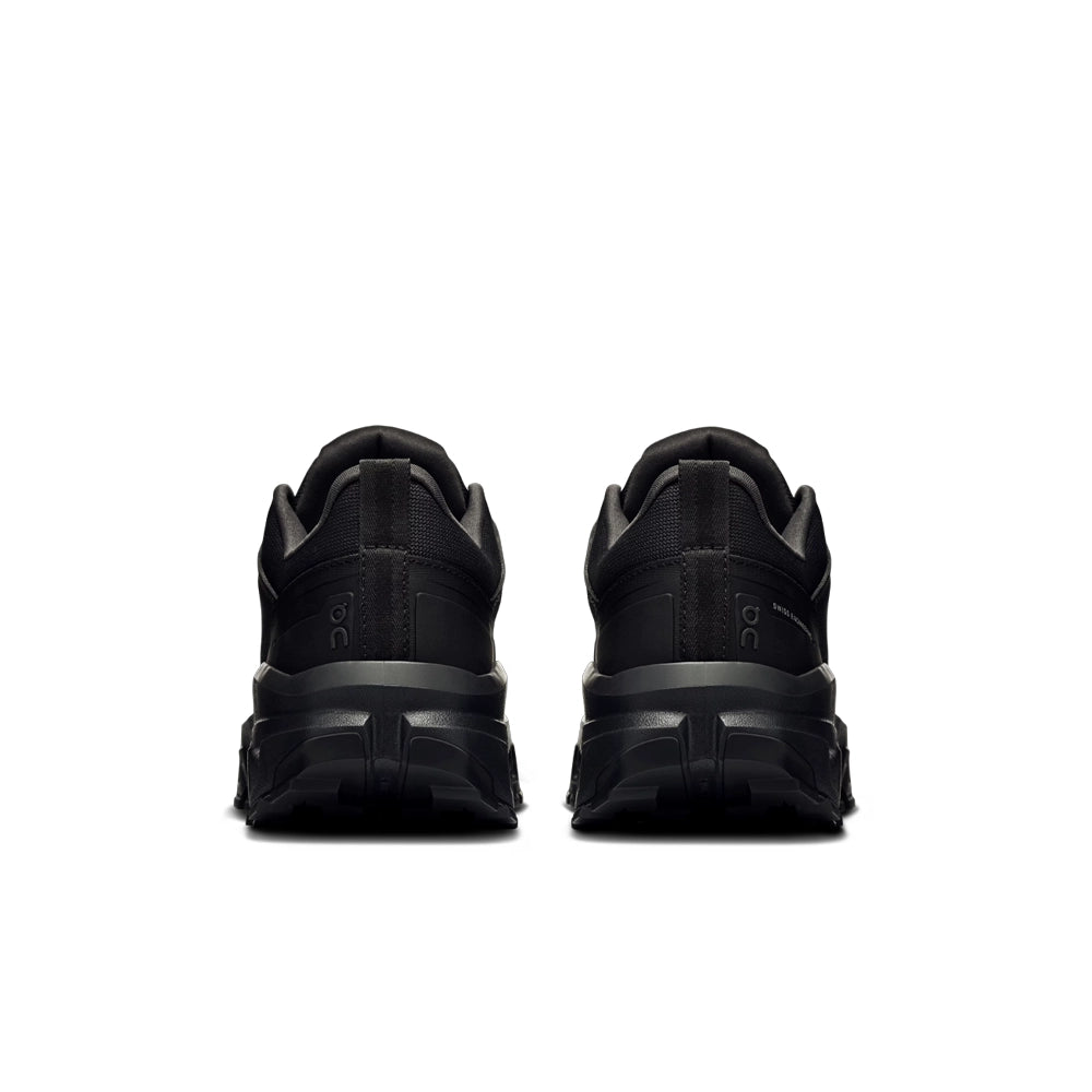 Rear view of the black On Cloudrock Low Waterproof shoes, showing heel pull tabs and padded collars.