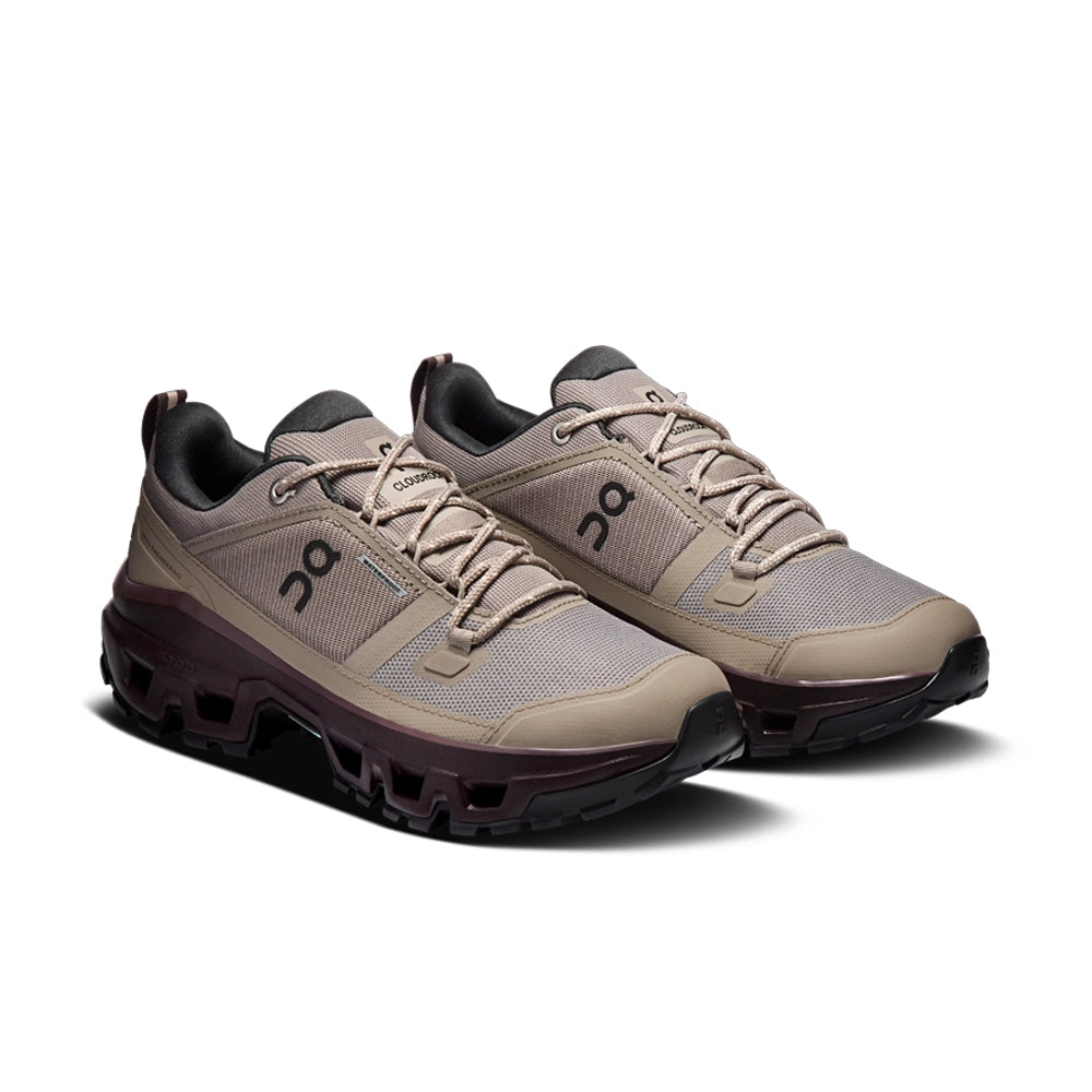 Pair of On women's Cloudrock Low Waterproof shoes in grayish-brown with dark brown soles, front three-quarter view.