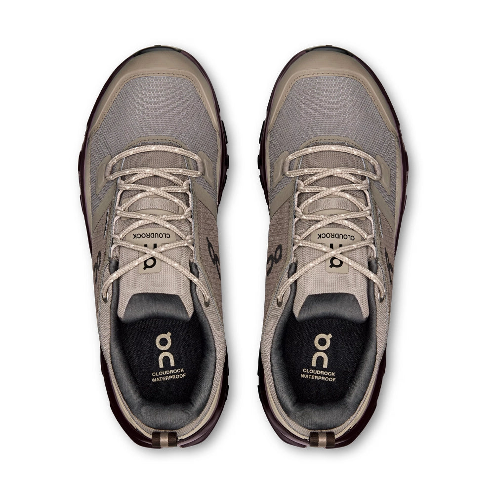 Top view of grayish-brown On Cloudrock Low Waterproof shoes with matching laces and black lining.