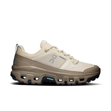 On women's Cloudrock Low Waterproof in Grain Soba, side view showing a cream mesh upper, grayish-brown overlays, and black outsole.