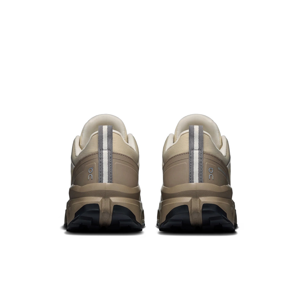 Rear view of On women's Cloudrock Low Waterproof shoes in Grain Soba, showing heel pull tabs and grayish-brown heel overlays.