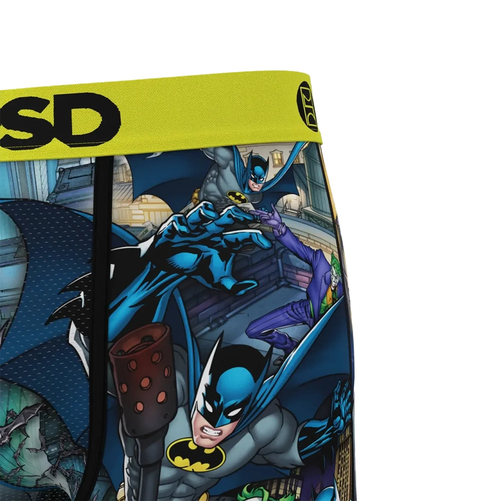 Close-up of PSD DC Batman Collage boxer briefs showing Batman comic artwork, black stitching, and the yellow waistband.