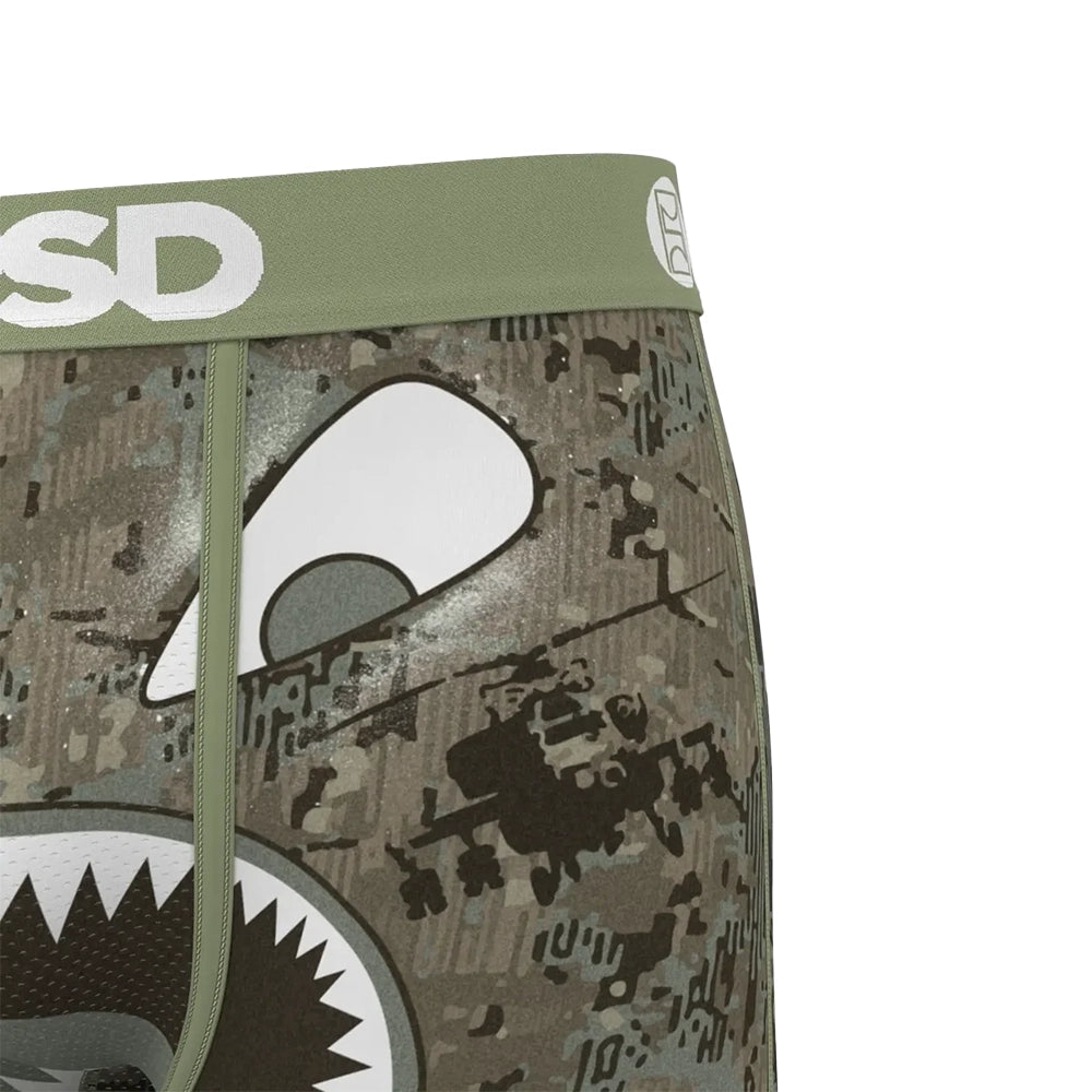 Close-up of PSD Warface Jungle boxer briefs showing the olive logo waistband, shark eye graphic and stitching.