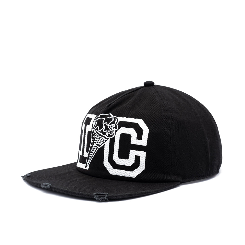A black flat-brim baseball cap with a distressed finish, featuring a white embroidered 'I' and 'C' design on the front with a skull and ice cream cone motif.