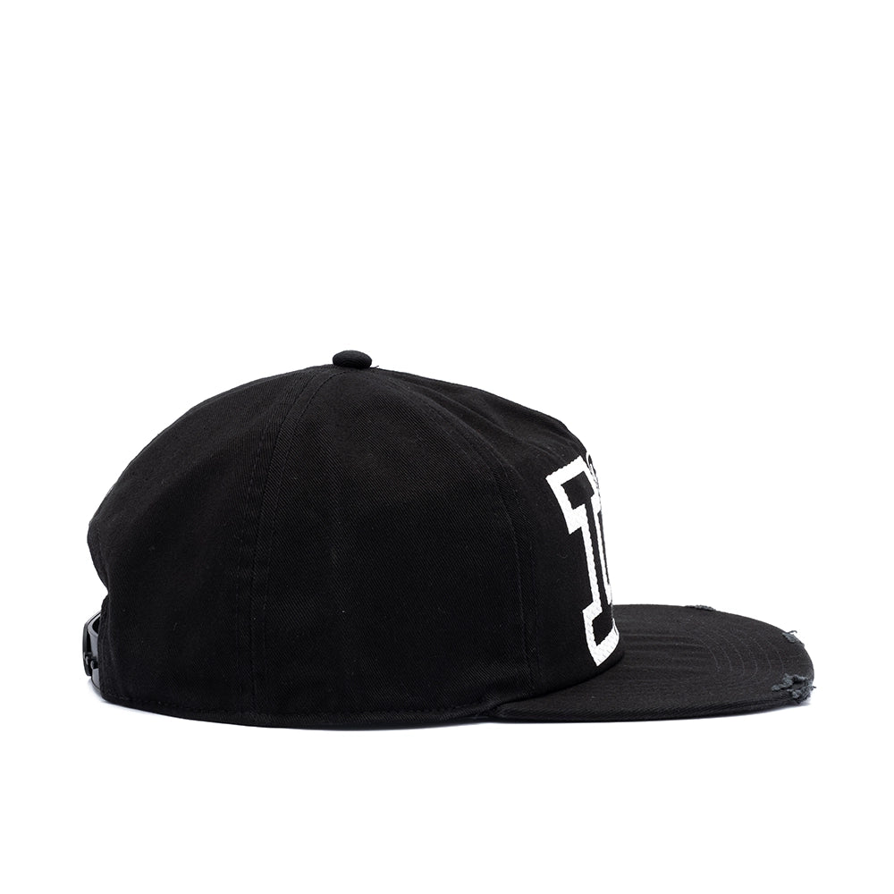 A black flat-brim baseball cap with a distressed finish and a white stylized 'I' logo on the side, shown against a plain white background.
