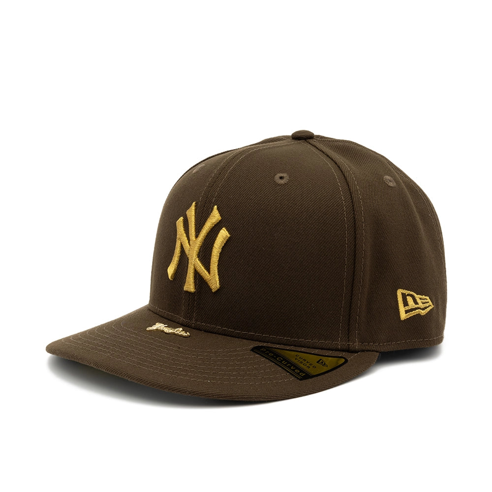 Angled view of walnut brown Yankees 59FIFTY fitted cap with gold NY and New Era logos.