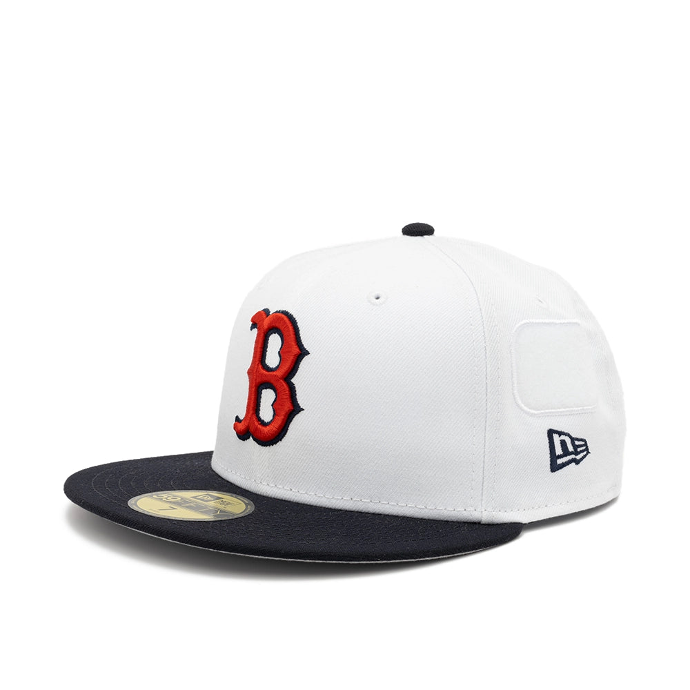Angled view of the white Boston Red Sox fitted cap with a red B logo, navy brim and embroidered New Era flag.