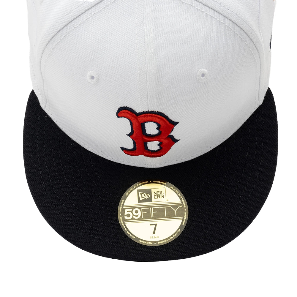 Top-front close-up of the white Boston Red Sox cap showing the embroidered red B logo and gold 59FIFTY brim sticker.