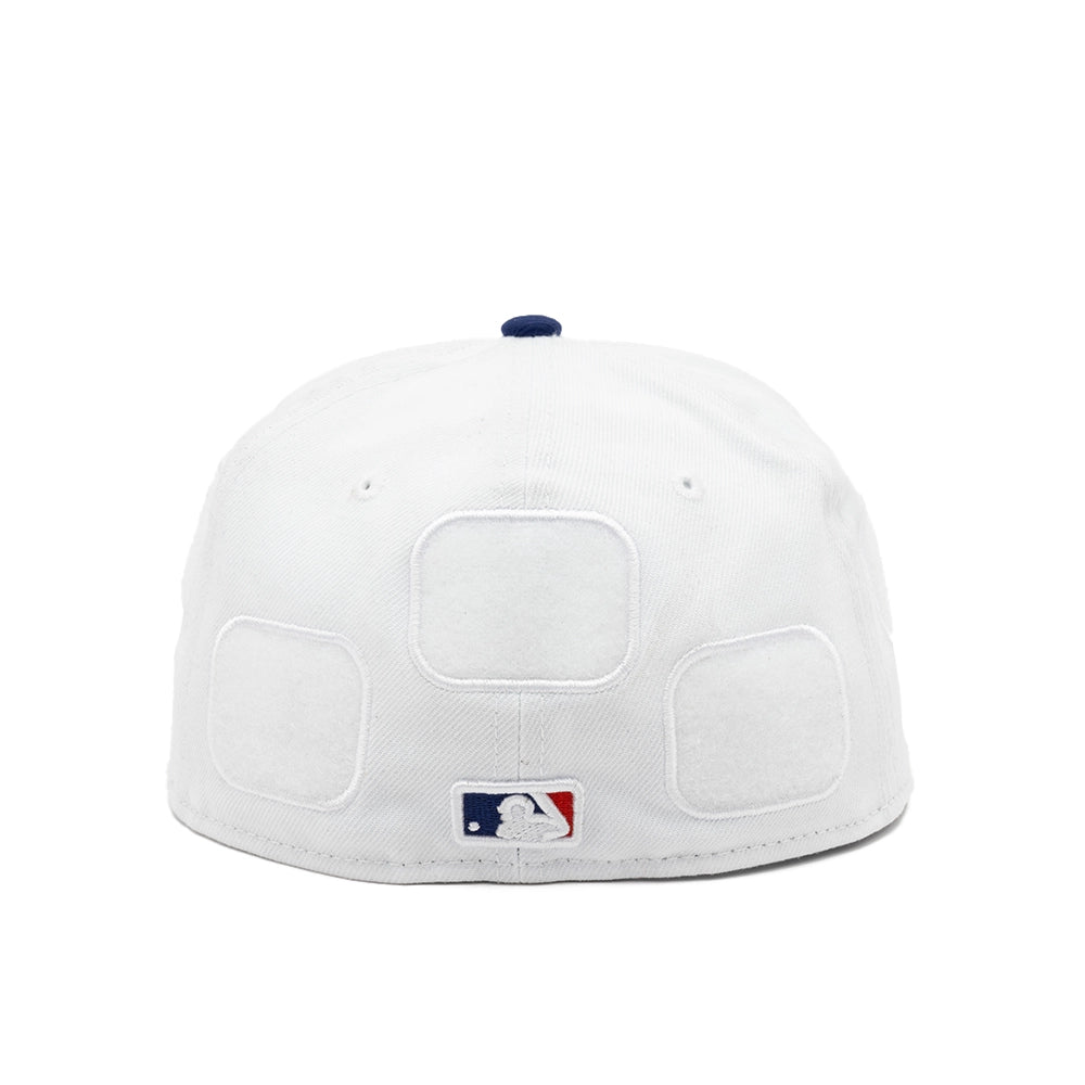 Back view of the white Dodgers fitted cap with three empty patch panels and an embroidered MLB logo.