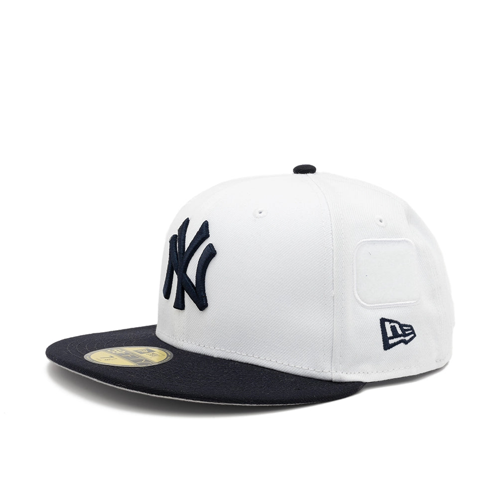 Front angled view of the white Yankees 59FIFTY cap with navy NY and New Era logos and an empty side patch panel.
