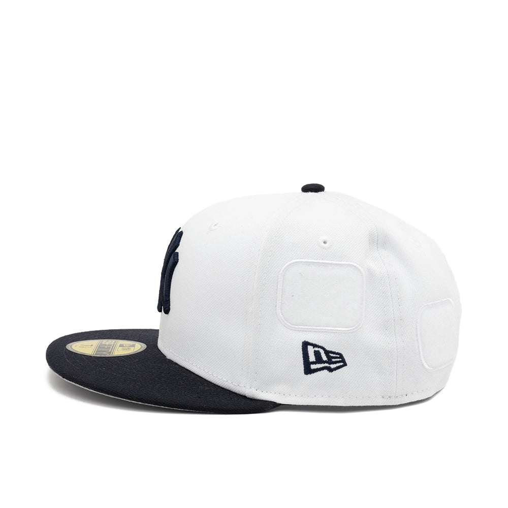 Side view of the white Yankees fitted cap with an embroidered navy New Era flag and empty patch panels.
