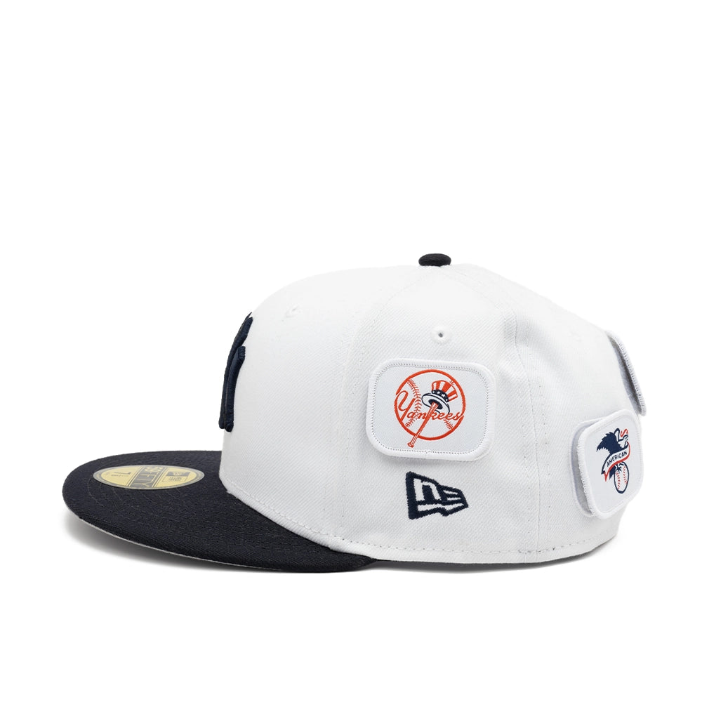 Side view of the white Yankees fitted cap with Yankees and American League patches above the navy New Era logo.