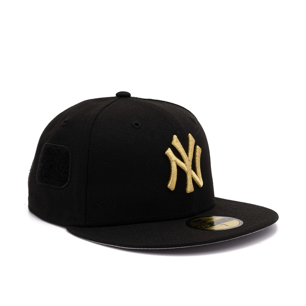 Opposite side view of black Yankees 59FIFTY fitted cap with gold NY logo and blank black patch