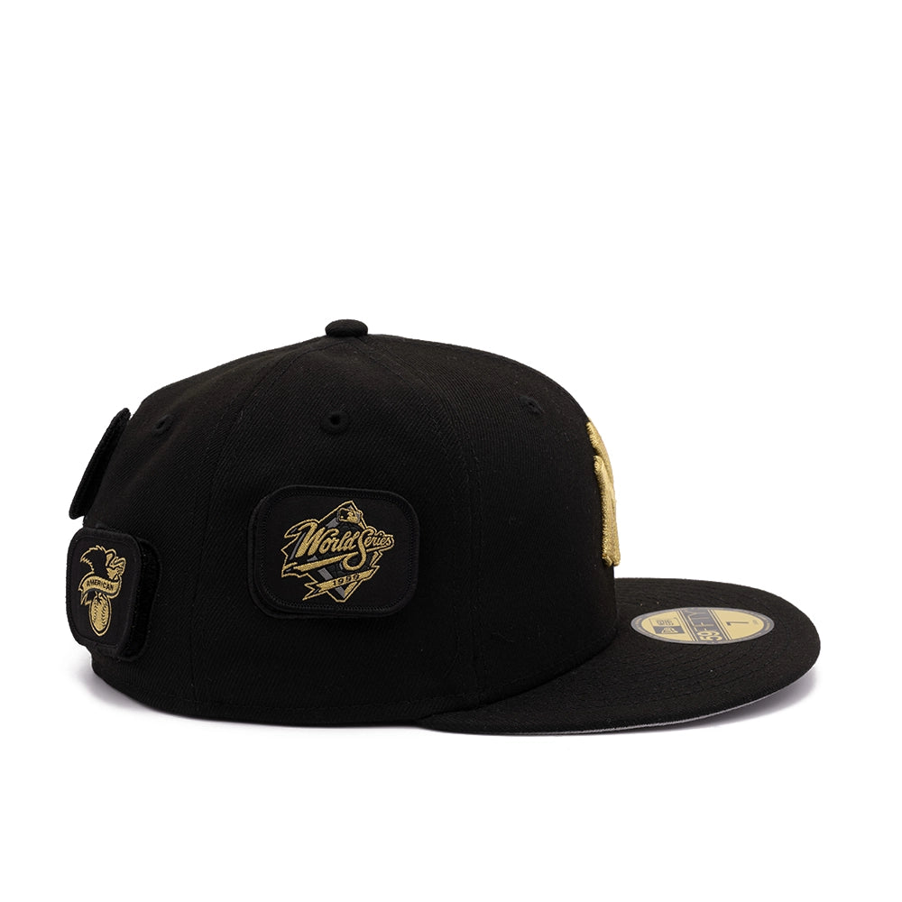 Side view of black Yankees 59FIFTY cap with gold World Series and American League patches
