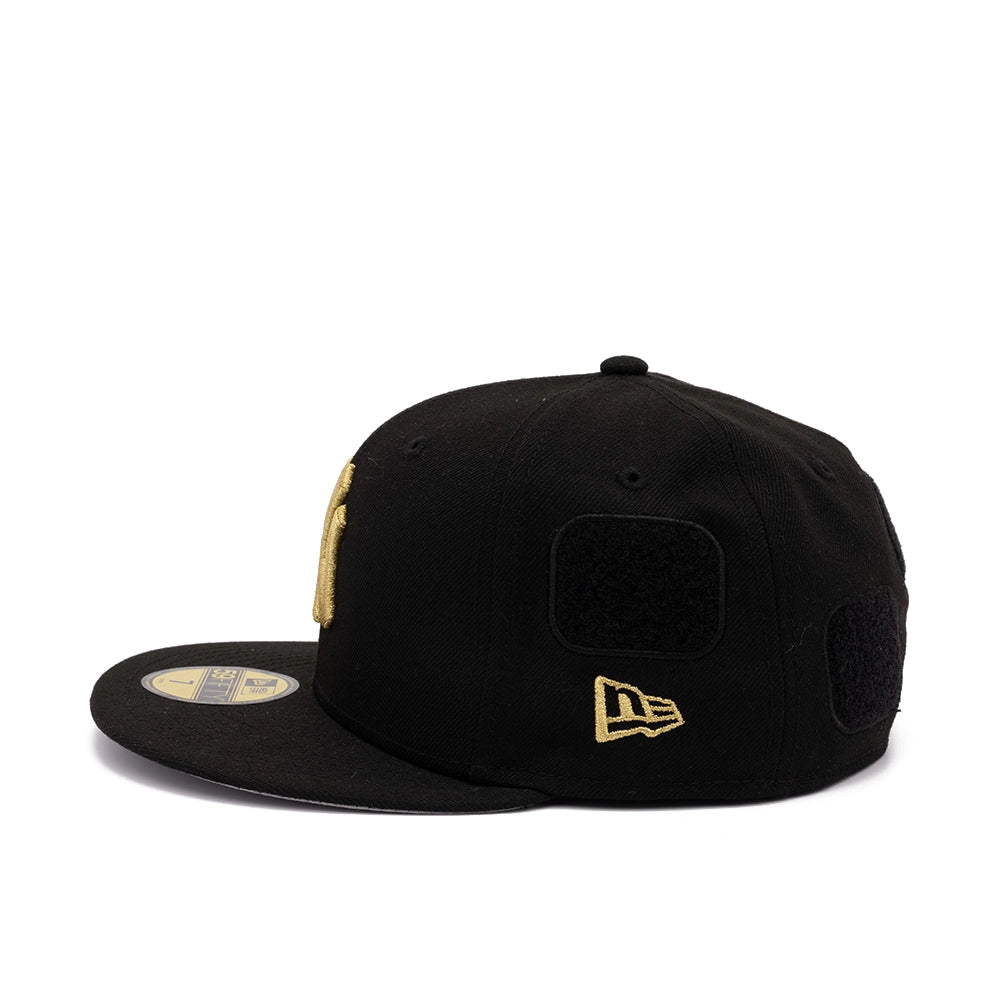 Side view of black Yankees 59FIFTY cap with gold New Era flag logo and blank black patch