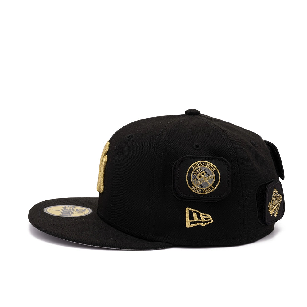 Side view of black Yankees 59FIFTY cap with gold 1903-1952 50th year patch and New Era flag