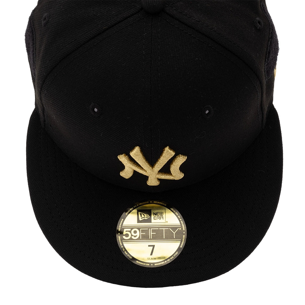 Top view of black Yankees 59FIFTY cap front panel with gold NY logo and New Era size sticker