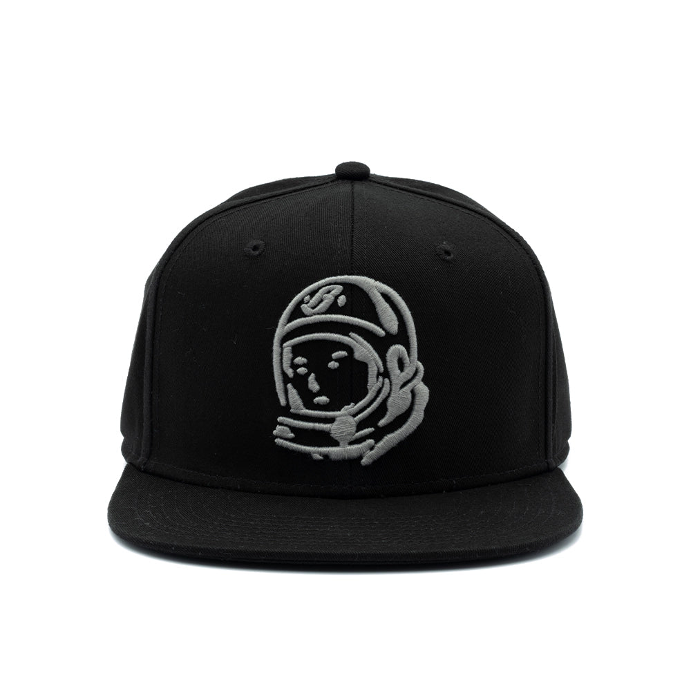 A black flat-brim snapback cap featuring an embroidered gray astronaut helmet logo on the front, set against a plain white background.