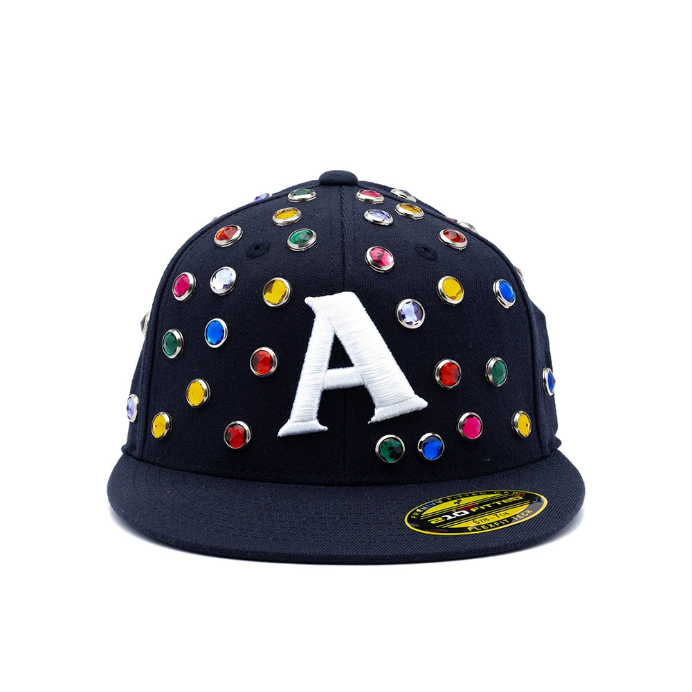 A black flat-brim baseball cap adorned with colorful rhinestones and a large white embroidered letter 'A' on the front, shown against a plain white background.