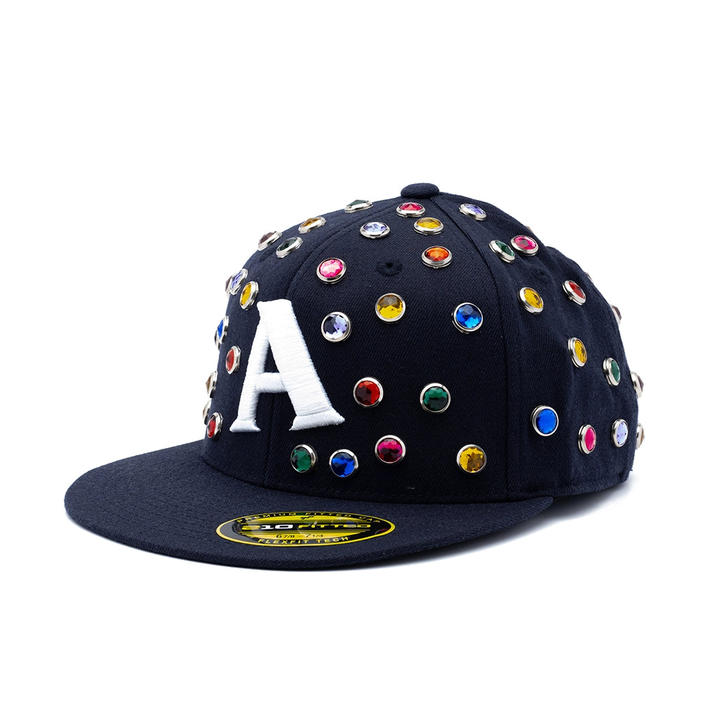 A black flat-brim baseball cap adorned with colorful rhinestone studs and a large white embroidered letter 'A' on the front, shown against a plain white background.