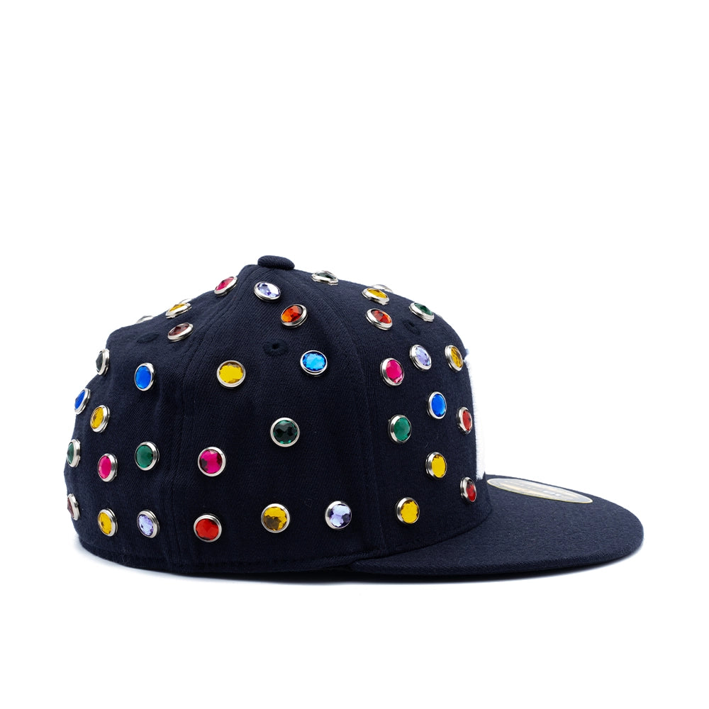 A black flat-brim baseball cap embellished with numerous colorful rhinestone studs in red, blue, yellow, green, pink, and silver, shown against a plain white background.
