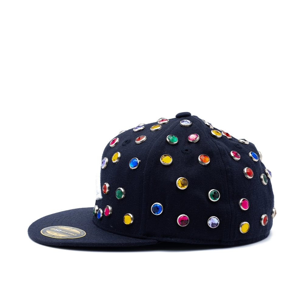 A black flat-brim baseball cap embellished with numerous colorful rhinestones in silver settings, shown from a side profile on a white background.