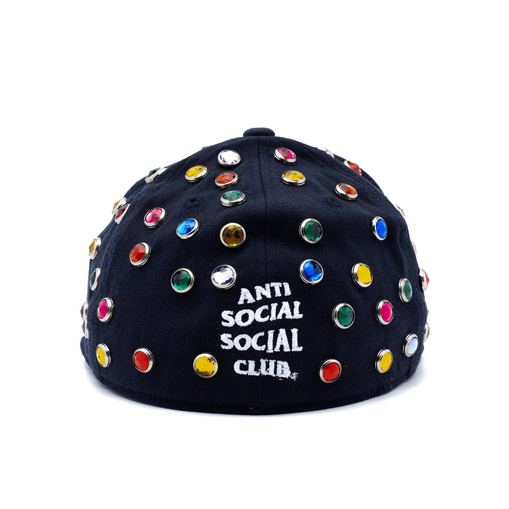 A black baseball cap by Anti Social Social Club, embellished with colorful rhinestone studs and featuring white embroidered text on the back, set against a plain white background.