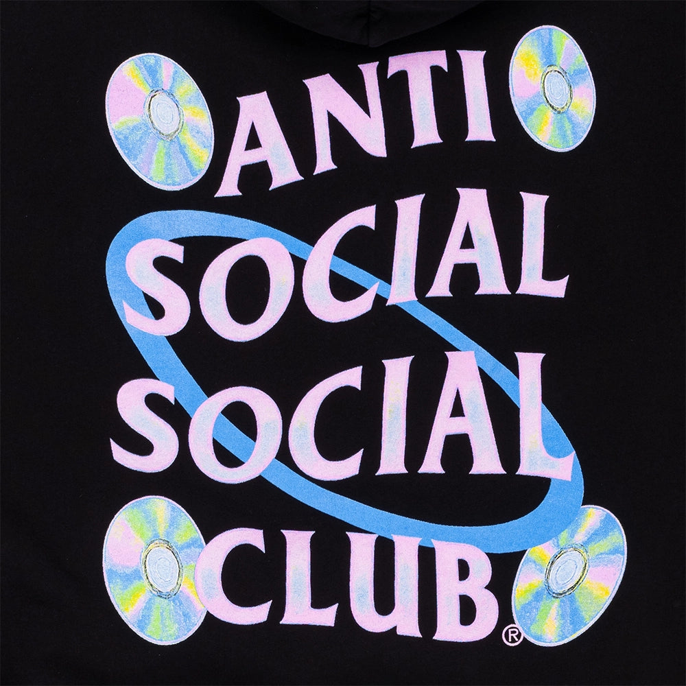 Close-up of a black hoodie featuring a large graphic print with the text 'ANTI SOCIAL SOCIAL CLUB' in pale pink letters, crossed by a light blue oval, with four iridescent CD illustrations on a black background.