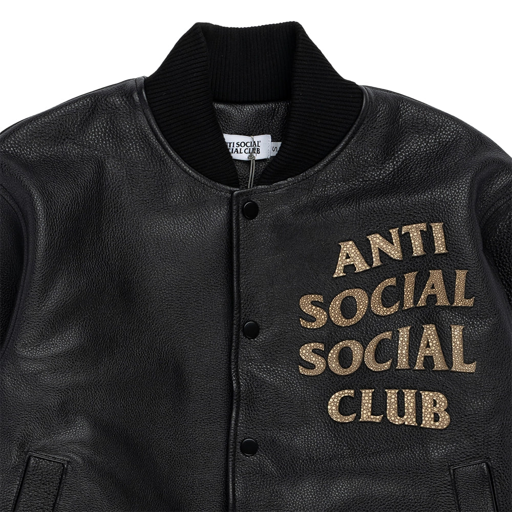 Close-up of ribbed collar, snap buttons and snakeskin appliqué chest logo on black Anti Social Social Club bomber.