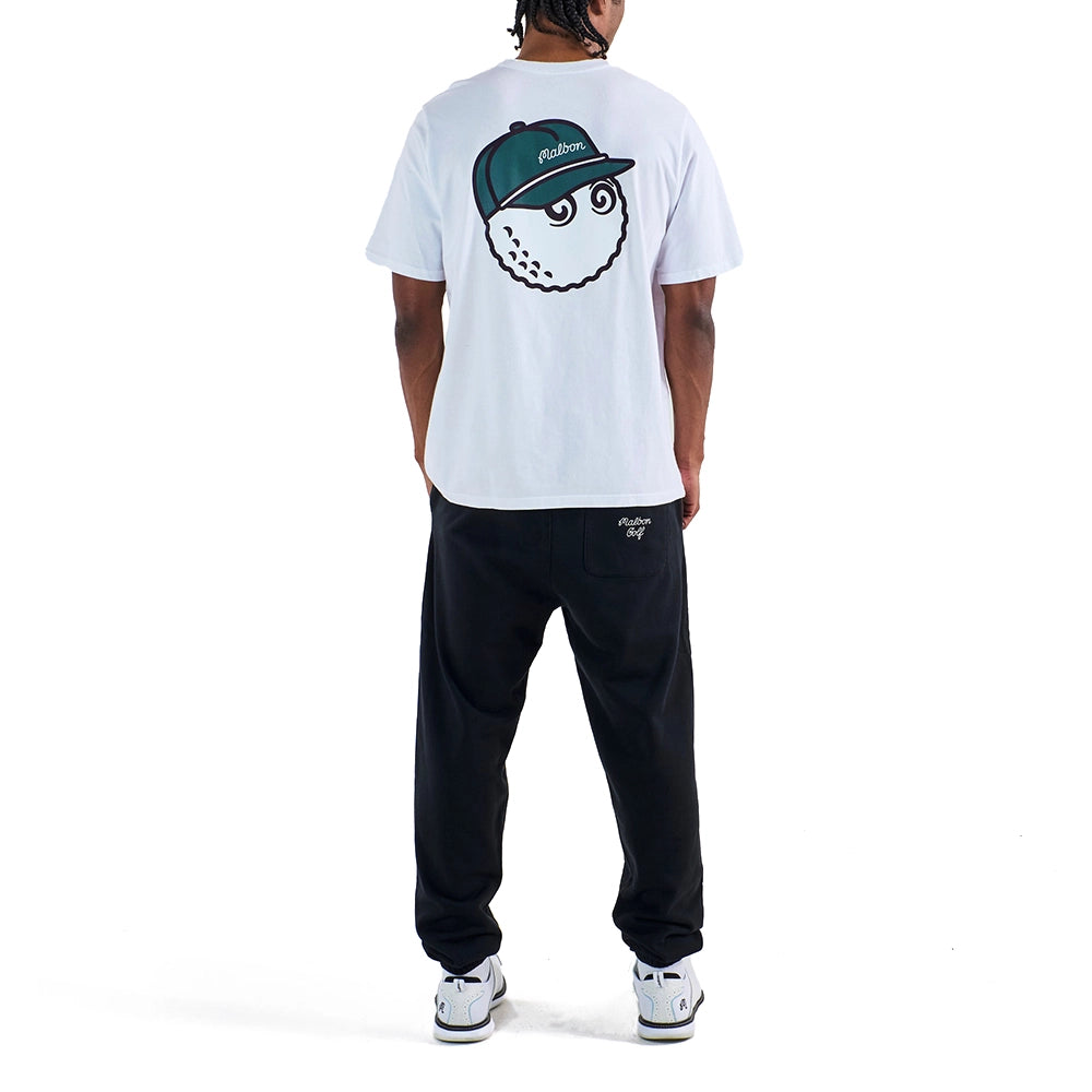 Rear view of a model wearing a white Malbon Bermuda Baldwin T-shirt with a golf ball graphic wearing a green cap