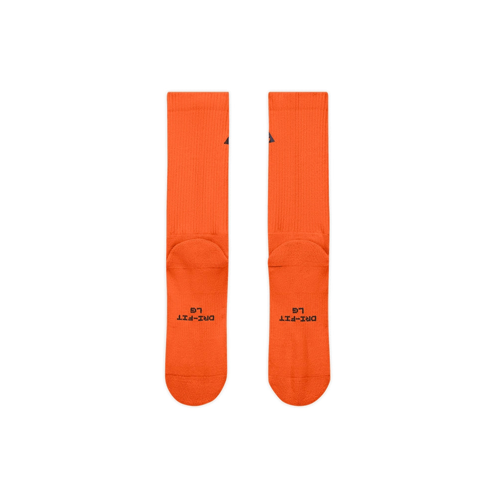 Sole view of Safety Orange Nike ACG crew socks with black Dri-FIT lettering.