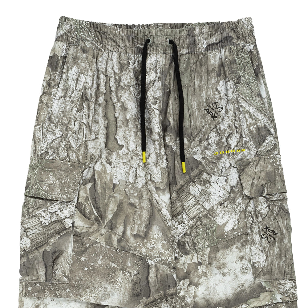 Close-up of the elastic waistband, black drawstrings and cargo pockets on Jordan Brooklyn Realtree pants.