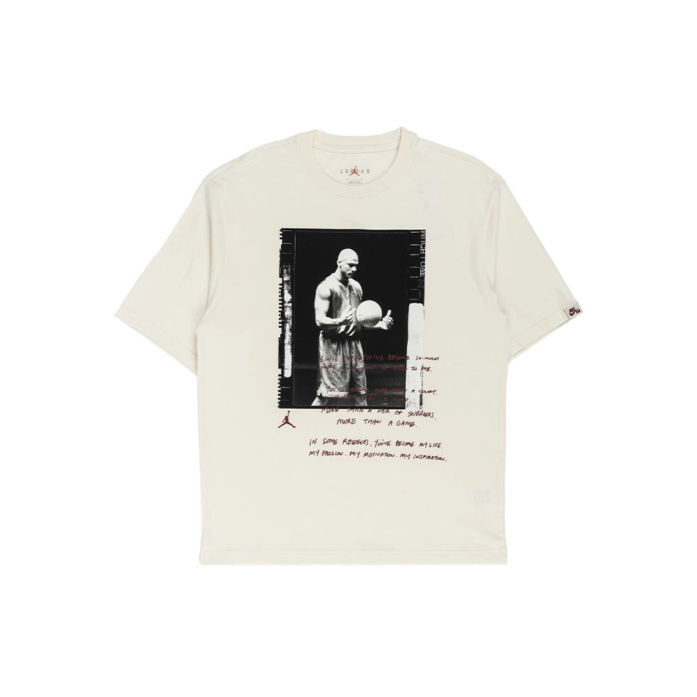An off-white short-sleeve t-shirt featuring a central black-and-white graphic print of a basketball player, with red handwritten-style text and a small Jordan logo on the left sleeve.