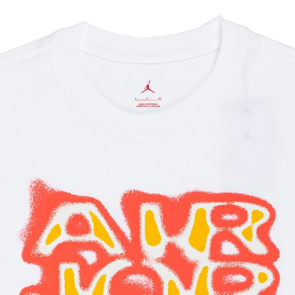 Close-up of the white Jordan Brooklyn '85 T-shirt showing the ribbed crew neck, printed Jumpman label, and upper chest graphic.
