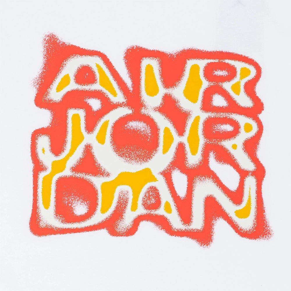 Close-up of the textured orange and yellow Air Jordan lettering on the white Jordan Brooklyn '85 T-shirt.