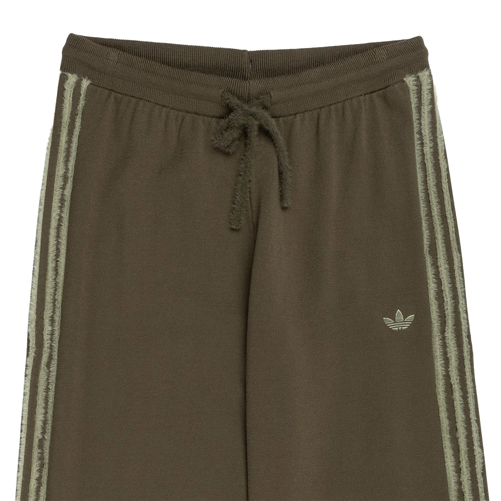 Close-up of the drawstring waistband, Trefoil logo and textured side stripes on adidas Knit Firebird track pants.