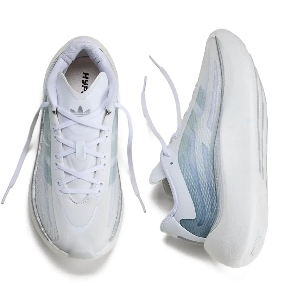 Sneakers in a monochromatic white and light blue colorway, showing the top-down and side-profile views against a clean white background.