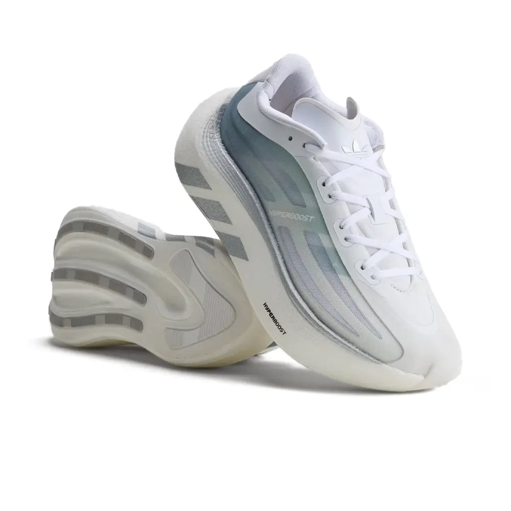 A pair of Adidas sneakers in white with light blue-gray accents on the side panels and translucent sole details, shown on a clean white background.