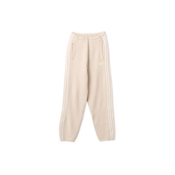 Front view of adidas x Jennie Bliss cream knit pants with balloon legs, side pockets and tonal 3-Stripes.