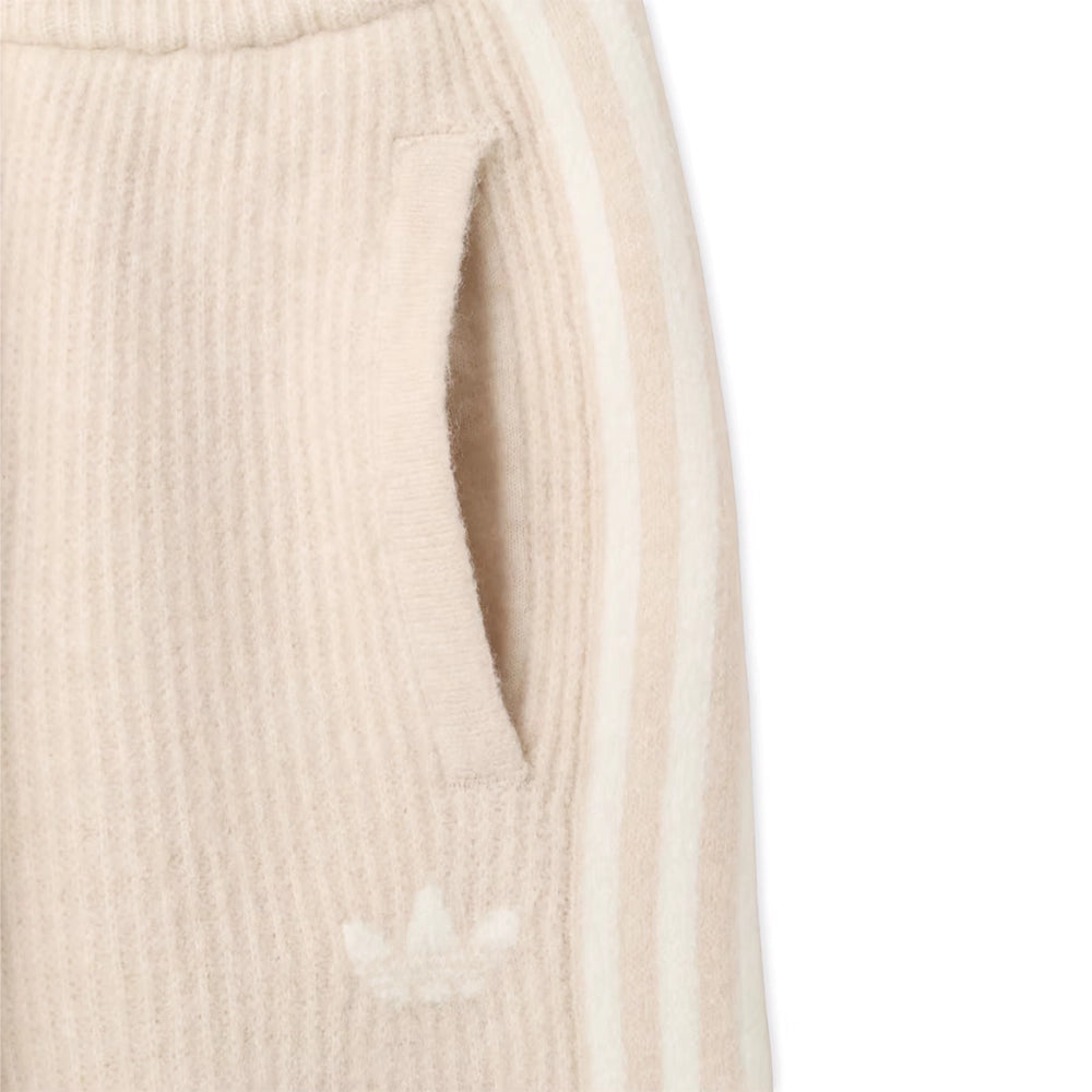 Close-up of the side pocket, Trefoil logo and tonal stripes on adidas x Jennie Bliss cream knit pants.