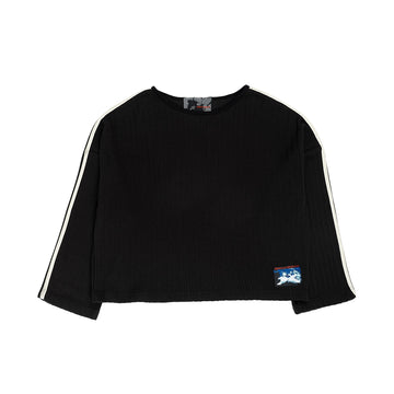 A black cropped long-sleeve top with white stripes down both sleeves and a small graphic patch on the lower left front, shown flat against a white background.