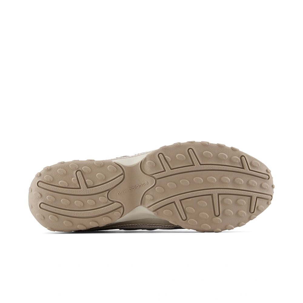 New Balance 204L Timberwolf Light Gold Metallic sneaker, outsole view showing tan tread with curved grooves.