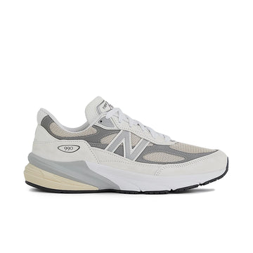 A New Balance sneaker in light gray, white, and beige, shown from a side profile view against a plain white background.