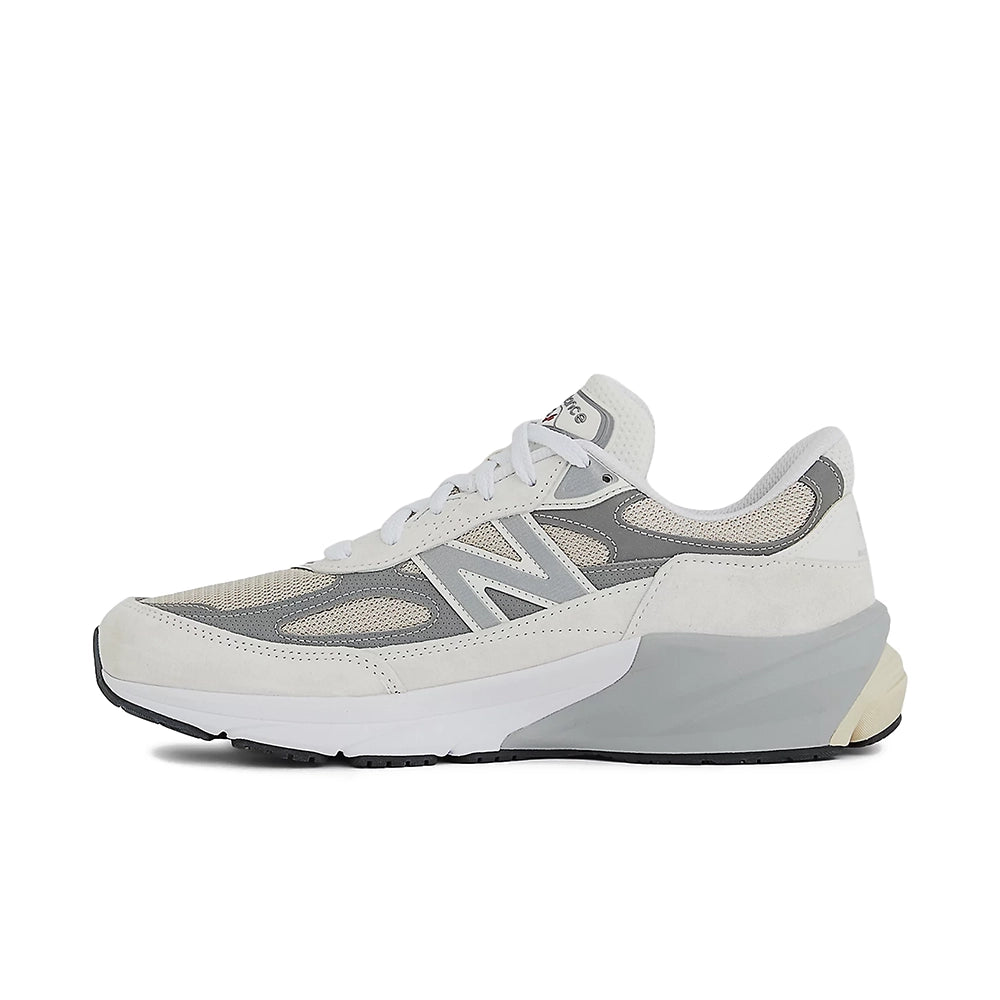 A New Balance sneaker in light gray and off-white, shown from a side profile view against a plain white background.